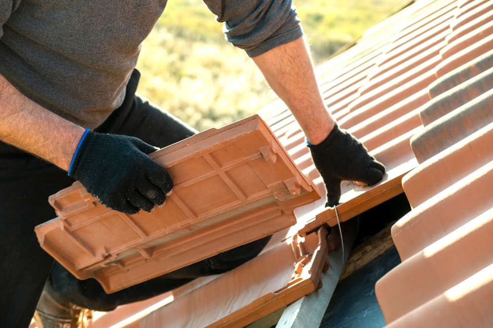 Roofing Worker Installing Shingles On A Roof